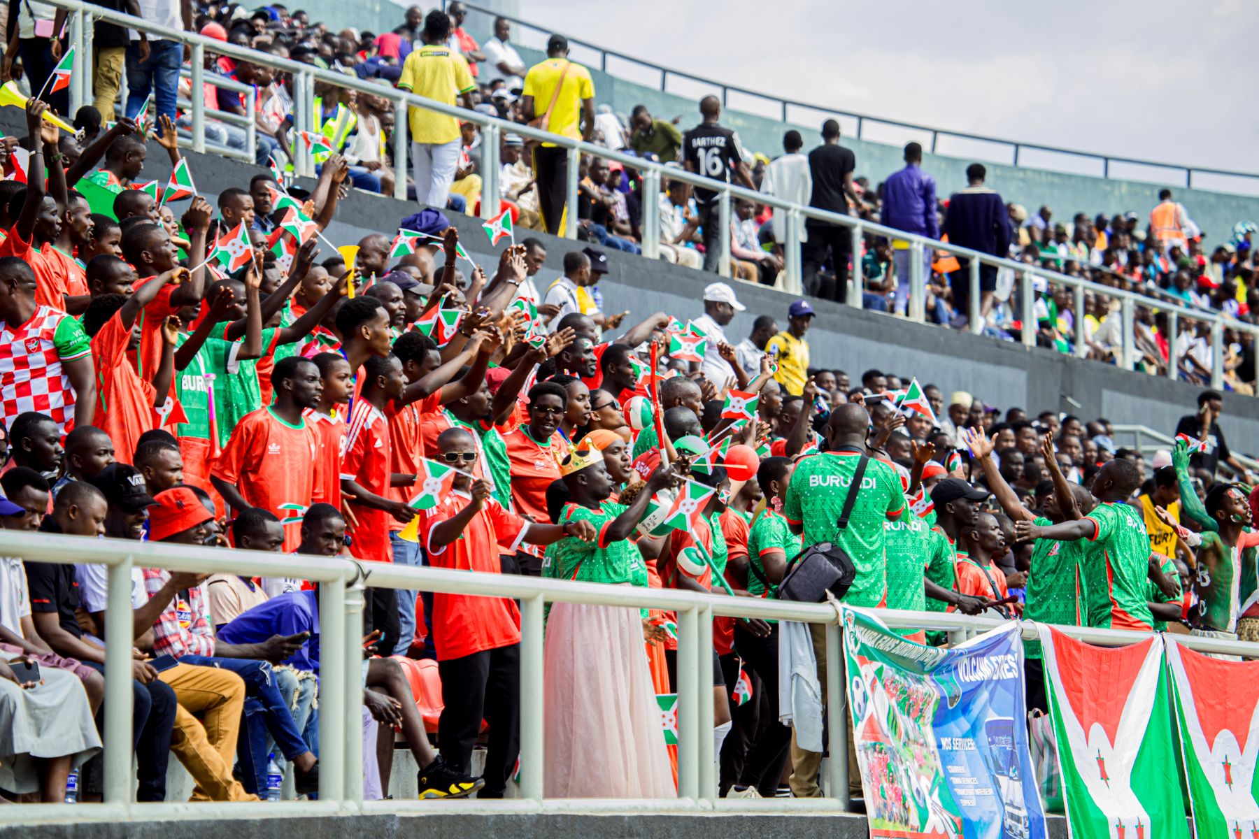 East African football supporters celebrating together in a stadium